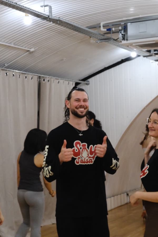 A beginner grinning after a class