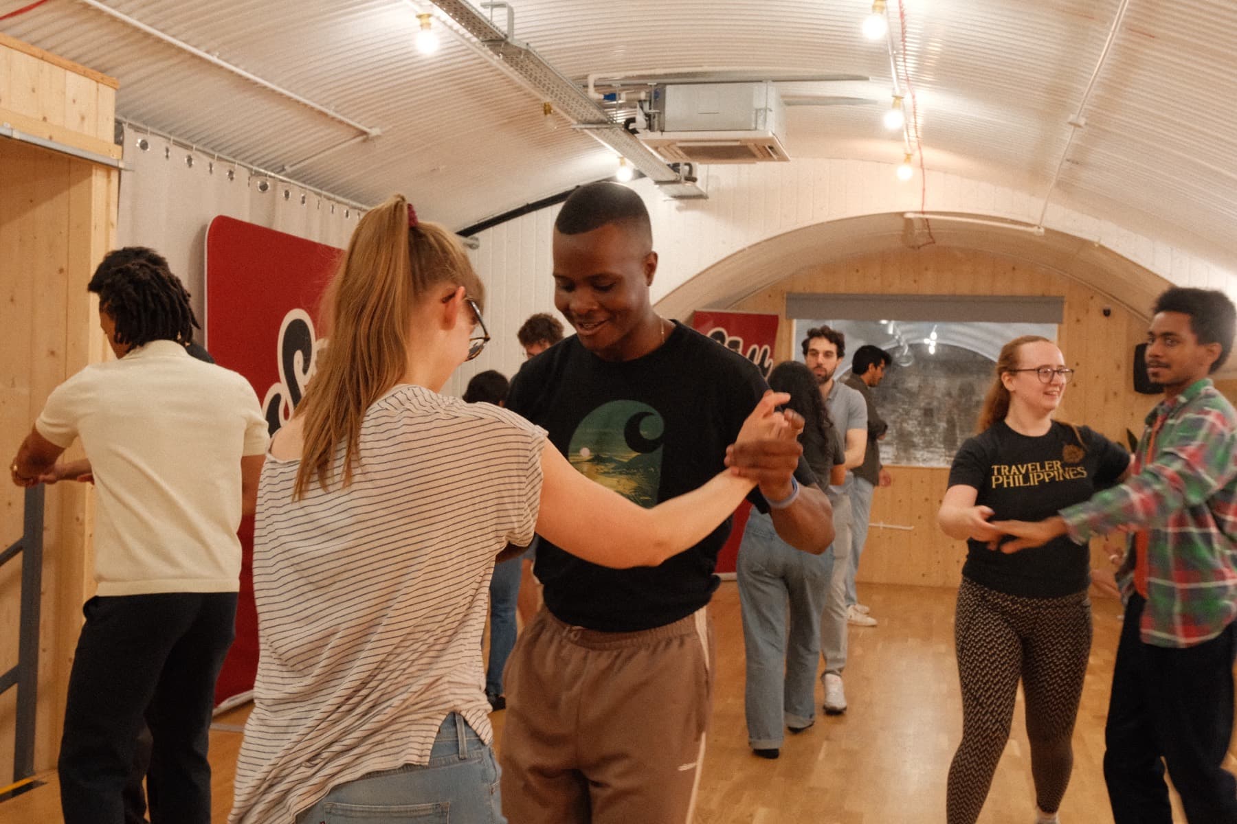 A Soy Salsa class dancing in pairs in London